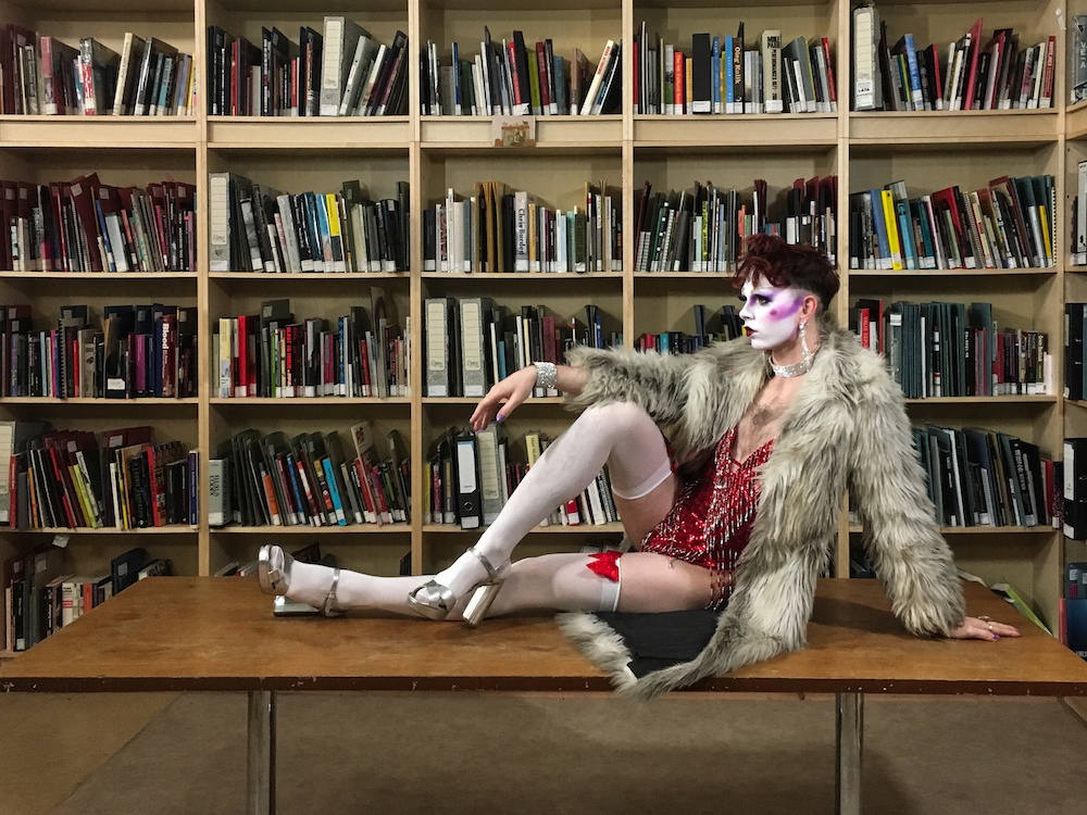 Finn Love sitting on a table elegantly in the LADA Study room