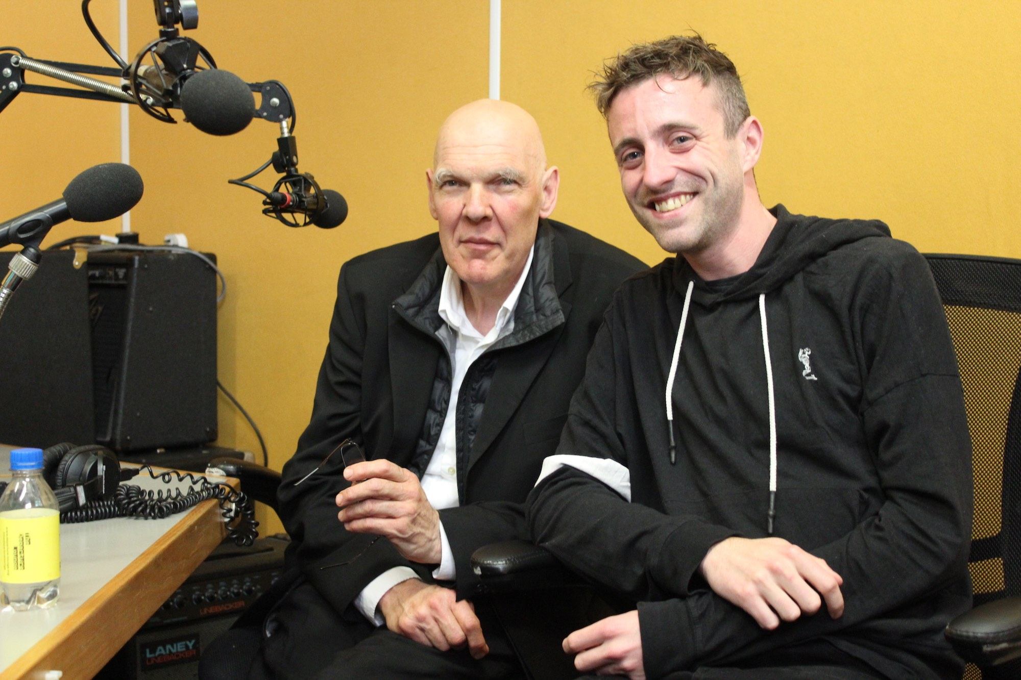 Nigel Rolfe and Martin O'Brien sit side by side in a radio recording studio