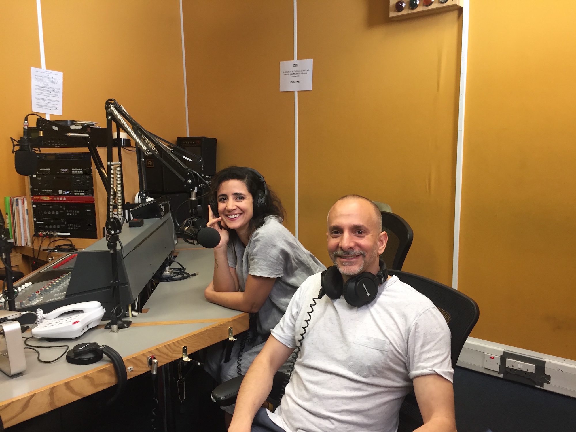 Joshua Sofaer and Tania El Khoury sit side by side in a radio recording studio
