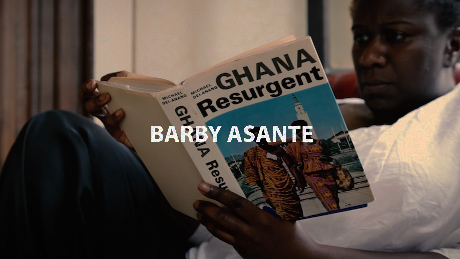 The artist reads a book titled 'Ghana Resurgent'